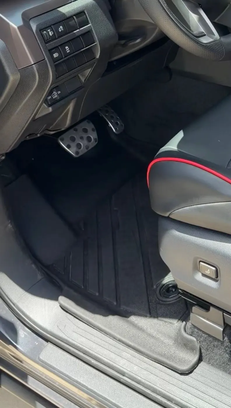 The Tacoma's driver footwell after work, the mat washed and dried, the carpet beside it vacuumed out.